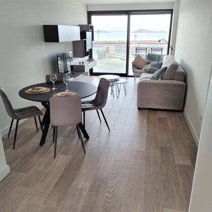 Living room with extendable table and TV with international channels and direct sea view